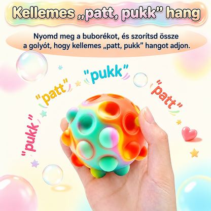 Pop it stresszlabda kézben – a buborékok benyomásakor patt, pukk hangot ad